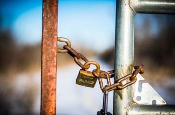 A padlock on a fence.