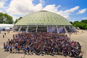 a group of people cheering in front of super block arena in Porto during WordCamp Europe 2022