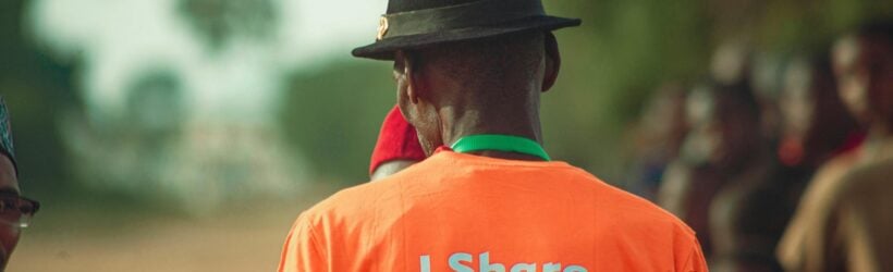 A person in a community event T-shirt, illustrating storytelling around a donation thank-you