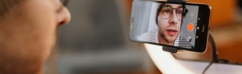 A person recording a video on a phone, illustrating a Why I Give supporter video campaign