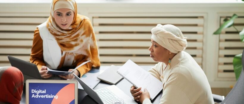 A digital advertising team planning a nonprofit campaign at a laptop, the disciplined process behind effective paid ads