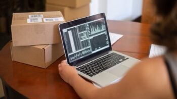 WooCommerce store owner reviewing performance data on a laptop