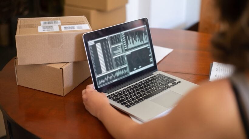 WooCommerce store owner reviewing performance data on a laptop