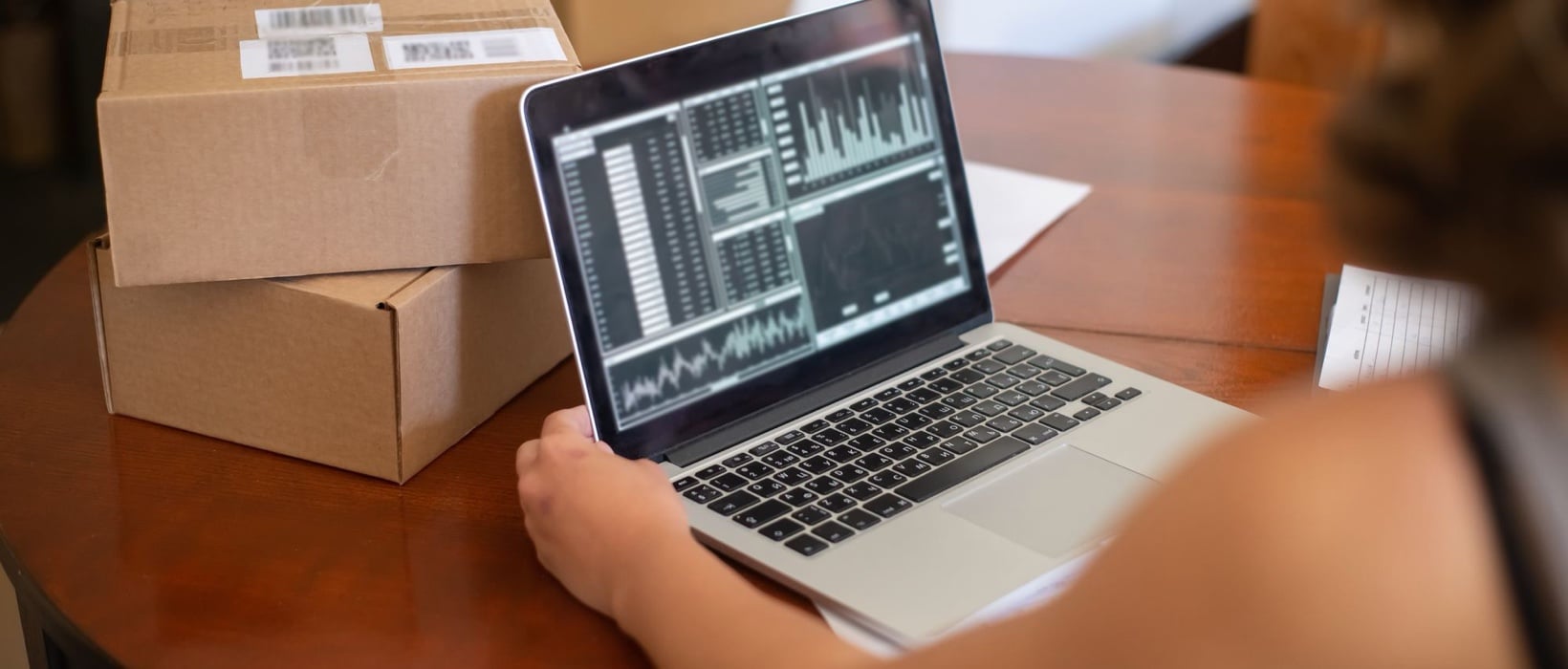 Shop owner reviewing WooCommerce performance data on a laptop