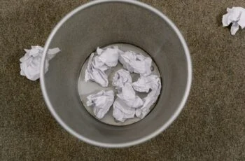 Overhead view of an office waste basket filled with crumpled paper