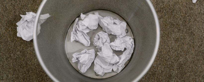 Deleting Shopify products in bulk, shown as crumpled paper in an office waste basket